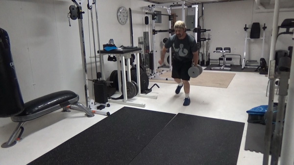 Pass-Under Walking Lunges With a Dumbbell