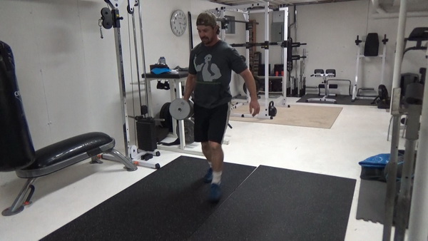 Pass-Under Walking Lunges With a Dumbbell