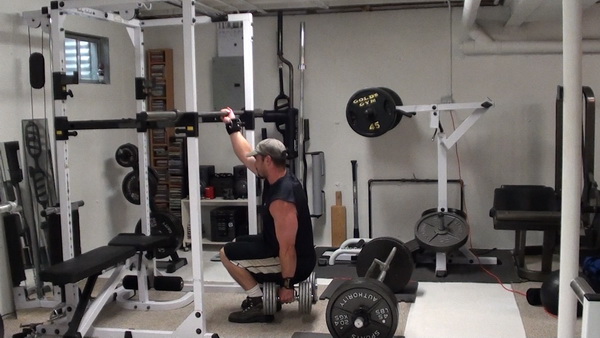 One-Arm Gripping Dumbbell Squats