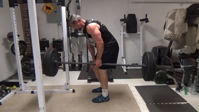 Build a Thicker Upper Back With One-Arm Suitcase Barbell Rows