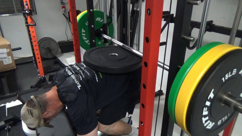 Smith Machine Donkey Calf Raises With a Bumper Plate position